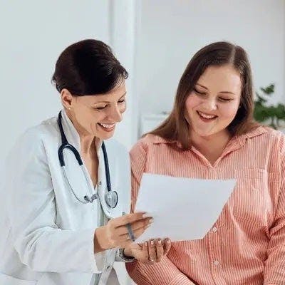 A person discussing medication changes with her emed healthcare provider